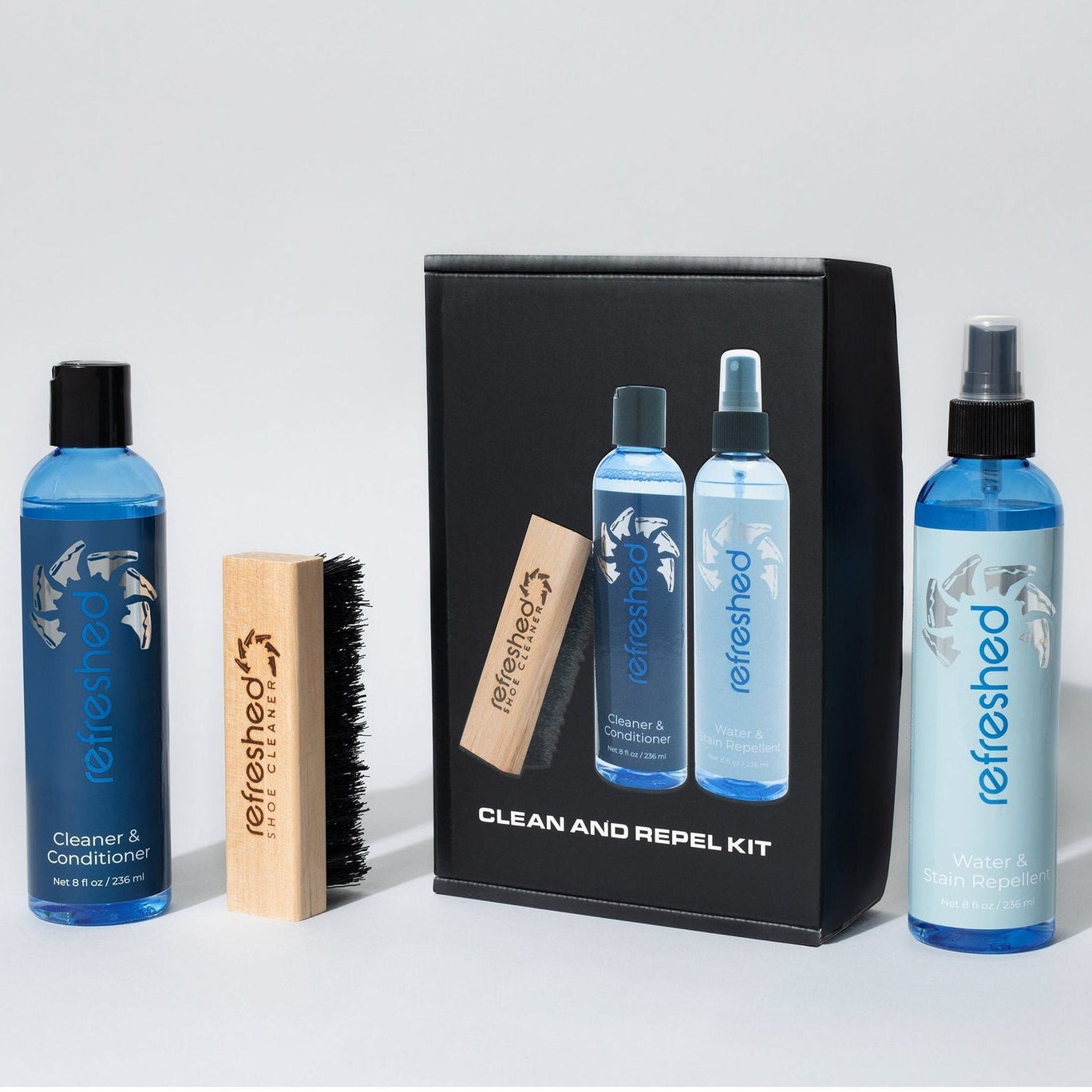 Clean and repel kit with bottles and a brush on a white background